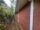 Brick home with greenery around the exterior and small windows at 301 Sisson Ne Ave, Atlanta, GA 30317