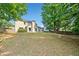 Expansive backyard features mature trees, offering privacy and shade at 4780 Agate Dr, Johns Creek, GA 30022