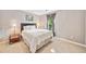 Cozy bedroom with neutral walls, carpet, side table and large window at 4780 Agate Dr, Johns Creek, GA 30022