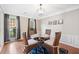 Charming dining area with hardwood floors, modern chandelier, and a cozy atmosphere for intimate gatherings at 4780 Agate Dr, Johns Creek, GA 30022