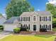 Charming two-story home with a well-manicured lawn, lush landscaping, and a convenient two-car garage at 4780 Agate Dr, Johns Creek, GA 30022