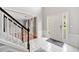 Bright foyer with tile flooring, staircase, and views to the living room and front door at 4780 Agate Dr, Johns Creek, GA 30022