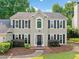Charming two-story home with black shutters, manicured landscaping, and a welcoming entrance at 4780 Agate Dr, Johns Creek, GA 30022