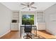 Bright home office with built-in bookshelves and a ceiling fan at 4780 Agate Dr, Johns Creek, GA 30022