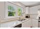 Bright kitchen with stainless steel sink and granite countertop at 4780 Agate Dr, Johns Creek, GA 30022