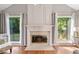 Bright living room with fireplace, large windows, and hardwood floors at 4780 Agate Dr, Johns Creek, GA 30022