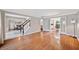 Spacious living room seamlessly connecting to the dining area, featuring hardwood floors and abundant natural light at 4780 Agate Dr, Johns Creek, GA 30022