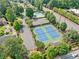 Overhead view of community tennis courts and pool, surrounded by lush trees at 4780 Agate Dr, Johns Creek, GA 30022