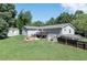 Expansive backyard with a wooden deck, storage shed, and car port, offering ample outdoor space at 8321 Banks Mill Rd, Douglasville, GA 30135