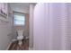 Neutral bathroom featuring toilet, towel rack, and unique wood-look flooring at 8321 Banks Mill Rd, Douglasville, GA 30135
