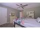 Bright bedroom with neutral tones, a ceiling fan, and ample closet space at 8321 Banks Mill Rd, Douglasville, GA 30135
