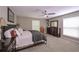 This bedroom has soft natural lighting, a ceiling fan, and a large bed at 8321 Banks Mill Rd, Douglasville, GA 30135