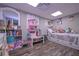 Bright bedroom with a dollhouse and plenty of storage for toys at 8321 Banks Mill Rd, Douglasville, GA 30135