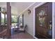 Cozy covered front porch with seating, hanging flowers, and a beautifully decorated front door at 8321 Banks Mill Rd, Douglasville, GA 30135