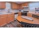 Cozy kitchen with wooden cabinets, white countertops, and stainless steel appliances at 8321 Banks Mill Rd, Douglasville, GA 30135