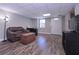Spacious living area with wood-look floors and ample natural light from the door and window at 8321 Banks Mill Rd, Douglasville, GA 30135