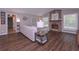 Comfortable living room with a stone fireplace, hardwood floors, and ample natural light at 8321 Banks Mill Rd, Douglasville, GA 30135
