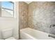 Bathroom with decorative tiled walls and bathtub at 847 Rolling Hill, Kennesaw, GA 30152