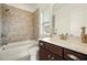 Bathroom features marble-patterned tile accent wall above tub and a dark wood vanity at 847 Rolling Hill, Kennesaw, GA 30152