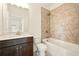 Bathroom featuring tub with shower, a dark wood vanity, and tile accent wall at 847 Rolling Hill, Kennesaw, GA 30152