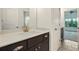 Bathroom features tile flooring, dark wood vanity and a view to the bedroom at 847 Rolling Hill, Kennesaw, GA 30152