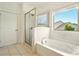 Bright bathroom featuring a soaking tub, a glass shower and a window with neighborhood view at 847 Rolling Hill, Kennesaw, GA 30152