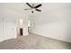 Spacious bedroom featuring neutral carpet, ceiling fan, and access to walk in closet at 847 Rolling Hill, Kennesaw, GA 30152