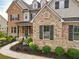 Close up of a beautiful home with stone and brick facade, well-maintained landscaping, and a welcoming entrance at 847 Rolling Hill, Kennesaw, GA 30152