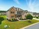 Charming two-story residence showcasing a blend of stone and brick, enhanced by lush greenery and a manicured yard at 847 Rolling Hill, Kennesaw, GA 30152