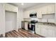 This kitchen features white cabinets, stainless steel appliances, and granite countertops at 847 Rolling Hill, Kennesaw, GA 30152