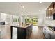 Open-concept kitchen with center island, granite countertops, and view to living area with fireplace at 847 Rolling Hill, Kennesaw, GA 30152