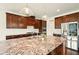 Kitchen with a pantry, stainless steel appliances, granite countertops, and dark wood cabinets at 847 Rolling Hill, Kennesaw, GA 30152