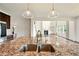Bright kitchen island featuring granite countertops, stainless steel sink, and pendant lighting at 847 Rolling Hill, Kennesaw, GA 30152
