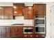 Modern kitchen features stainless steel microwave and double oven with dark cabinets and granite countertops at 847 Rolling Hill, Kennesaw, GA 30152