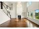 Gorgeous living room featuring a fireplace, beautiful floors, and backyard views at 847 Rolling Hill, Kennesaw, GA 30152
