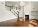 Sun-lit living room with hardwood floors, fireplace, and decorative chandelier at 847 Rolling Hill, Kennesaw, GA 30152