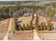 An aerial view showcases the home, long driveway, fence, and yard with mature evergreens at 212 Lakeview Dr, Newborn, GA 30056