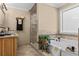 A bathroom features a soaking tub, walk-in shower, stone vessel sink, and tiled flooring at 212 Lakeview Dr, Newborn, GA 30056