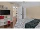 Bedroom with hardwood floors, view into study, and white shelving unit for storage at 212 Lakeview Dr, Newborn, GA 30056