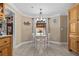 Cozy dining area with a table and chairs illuminated by a chandelier near windows at 212 Lakeview Dr, Newborn, GA 30056