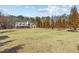 Beautiful home with stone exterior, manicured front yard, and tall trees enhancing curb appeal at 212 Lakeview Dr, Newborn, GA 30056
