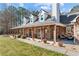 Inviting front porch with stone accents and comfortable seating area at 212 Lakeview Dr, Newborn, GA 30056
