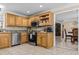 Bright kitchen features stainless steel appliances, tile backsplash, and light wood cabinetry at 212 Lakeview Dr, Newborn, GA 30056