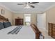Spacious main bedroom featuring a ceiling fan, and an ensuite bathroom visible through a doorway at 212 Lakeview Dr, Newborn, GA 30056