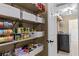 Well-stocked pantry with organized shelving and door leading to the laundry area at 212 Lakeview Dr, Newborn, GA 30056