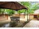 Back deck features outdoor dining set and an open view of the fenced-in backyard at 2568 Redfield Dr, Norcross, GA 30071