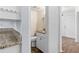 Modern powder room with granite countertop and wood-look tile flooring at 2568 Redfield Dr, Norcross, GA 30071