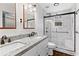 Modern bathroom featuring double sinks with granite counters and a glass-enclosed shower at 2568 Redfield Dr, Norcross, GA 30071