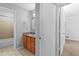 Bathroom view featuring shower/tub combo with wood cabinets and tiled floors at 2568 Redfield Dr, Norcross, GA 30071