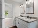 Beautiful bathroom with a double sink granite vanity, hardwood floors, and modern fixtures at 2568 Redfield Dr, Norcross, GA 30071